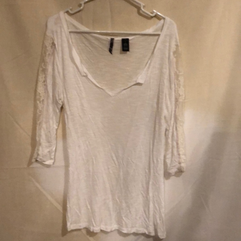 White shirt with lace sleeves.